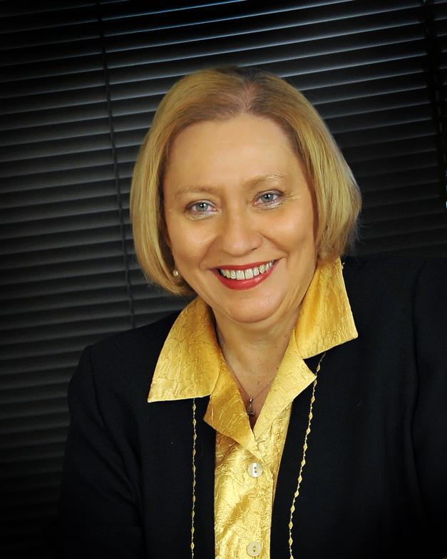 Vicki Hidde professional photo wearing black blazer with gold blouse 